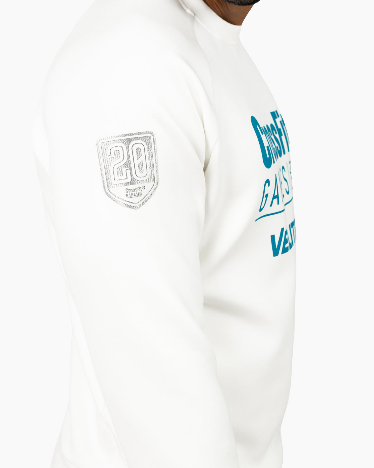 Close-up of the commemorative emblem patch on the sleeve of the pearl CrossFit Games sweatshirt