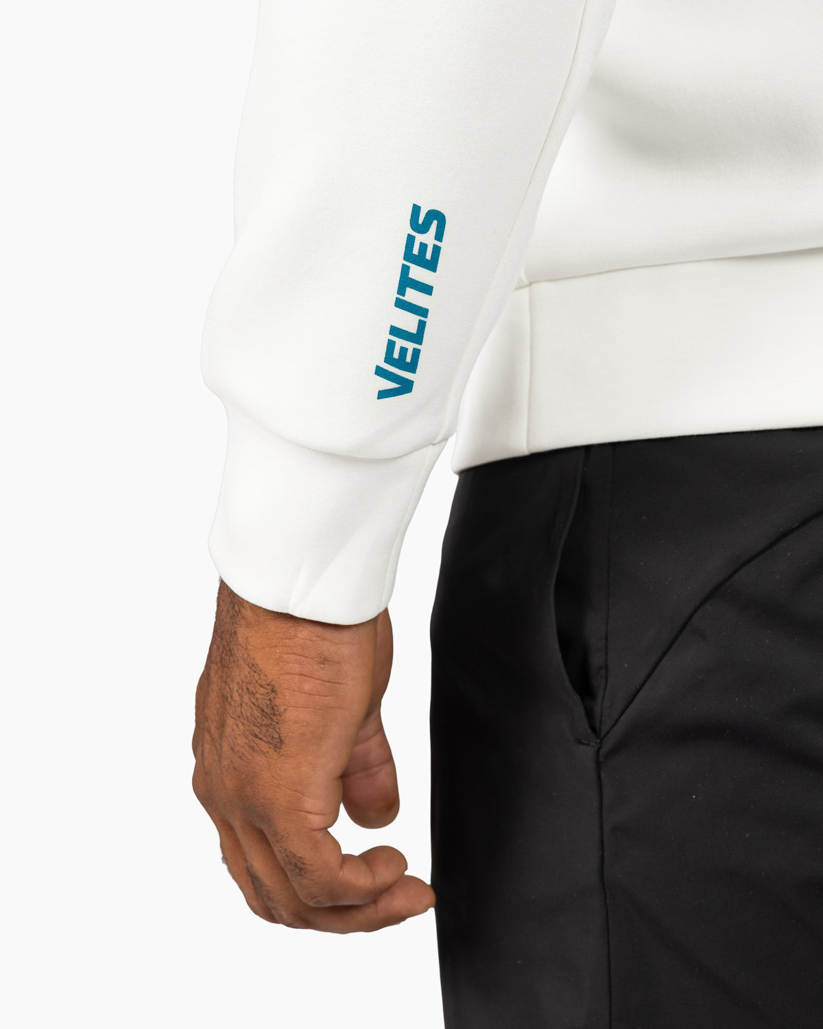 Close-up detail of the branded text graphic near the cuff of the Velites crewneck sweatshirt